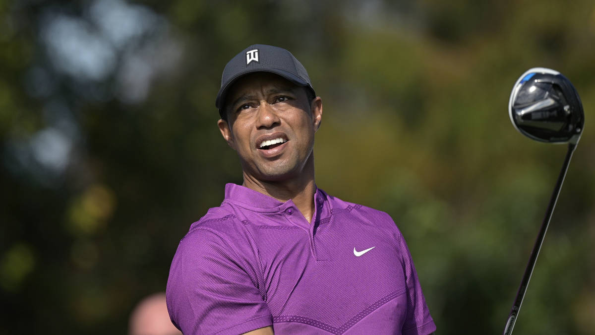 This Dec. 19, 2020, file photo shows Tiger Woods watching his tee shot on the first hole during ...
