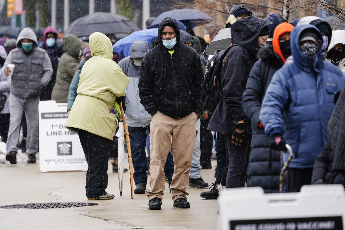 FILE - In this Feb. 19, 2021, file photo, people wait in line at a 24-hour, walk-up COVID-19 va ...
