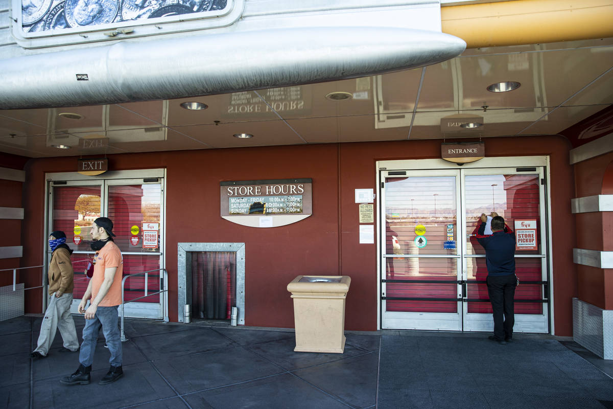 An employee who declined to give their name puts up a notice about the closure of Fry's Electro ...