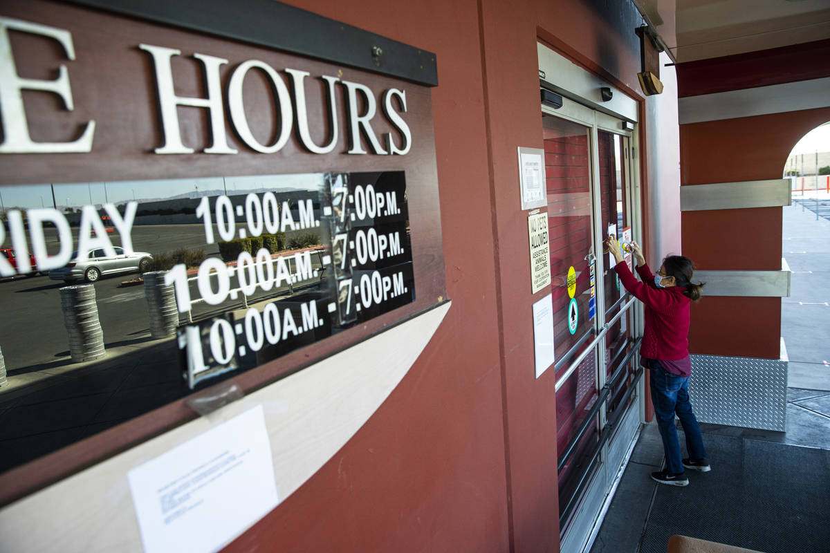 An employee who declined to give their name puts up a notice about the closure of Fry's Electro ...