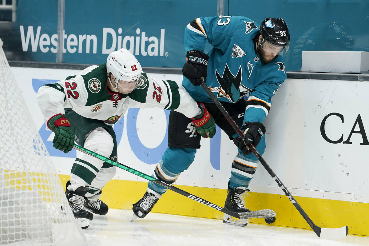 Minnesota Wild left wing Kevin Fiala (22) battles for the puck against San Jose Sharks defensem ...
