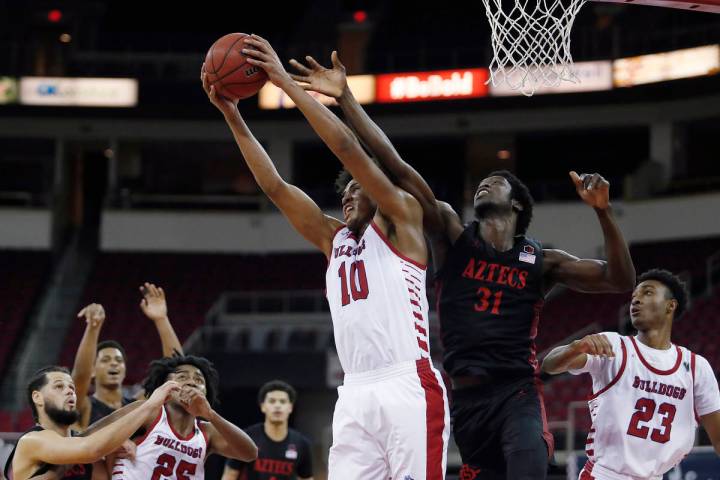 San Diego State's Nathan Mensah (31) and Fresno State's Orlando Robinson (10) reach for a rebou ...