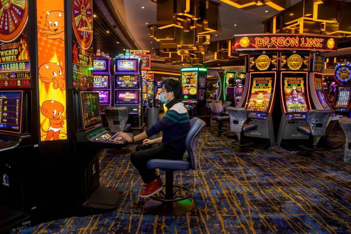 Zaw Naw of Denver plays the Hot Stuff Wicked Wheel slots on the casino floor at the Strat on We ...