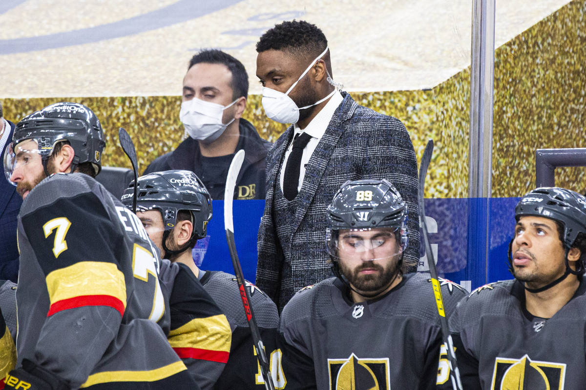 Silver Knights assistant coach Joel Ward, center, looks on from the Golden Knights bench during ...