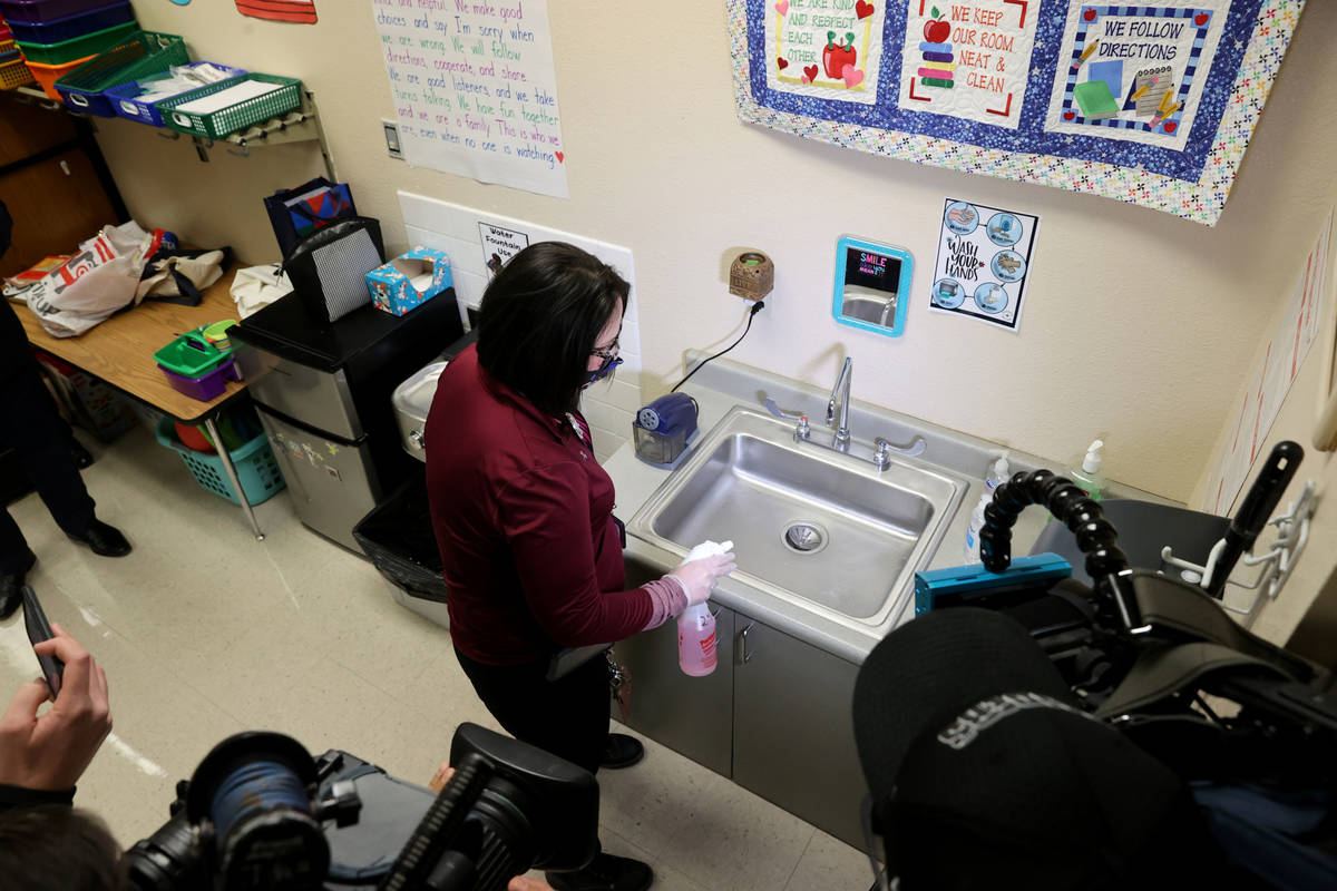 Clark County School District Support Staff Trainer Tia Baker sanitizes a classroom at Eisenberg ...