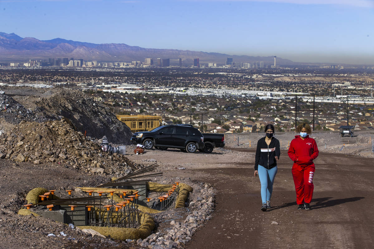 Miriam Hejji, left, and friend Nictoria Pleasant-Rede walk up from a construction site near the ...