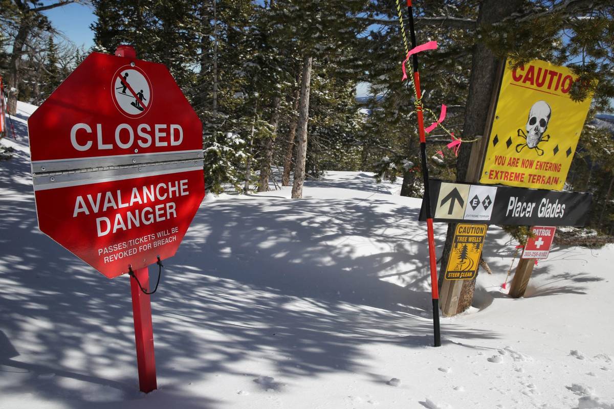 A sign alerts skiers to danger on Corona Bowl, known for its extreme skiing, at Eldora Mountain ...