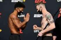 Opponents Alex Caceres, left, and Kevin Croom face off during the UFC weigh-in at UFC APEX on F ...