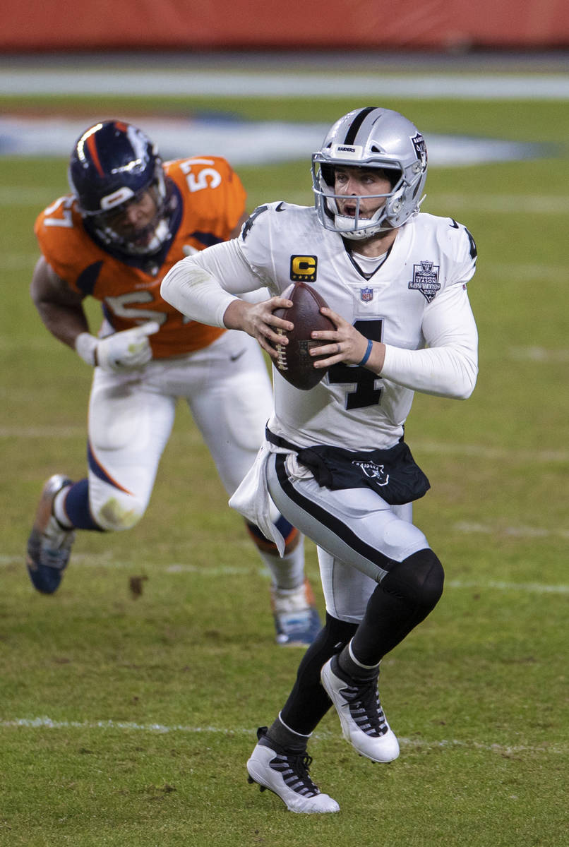 Raiders quarterback Derek Carr (4) scrambles past Denver Broncos defensive end DeMarcus Walker ...