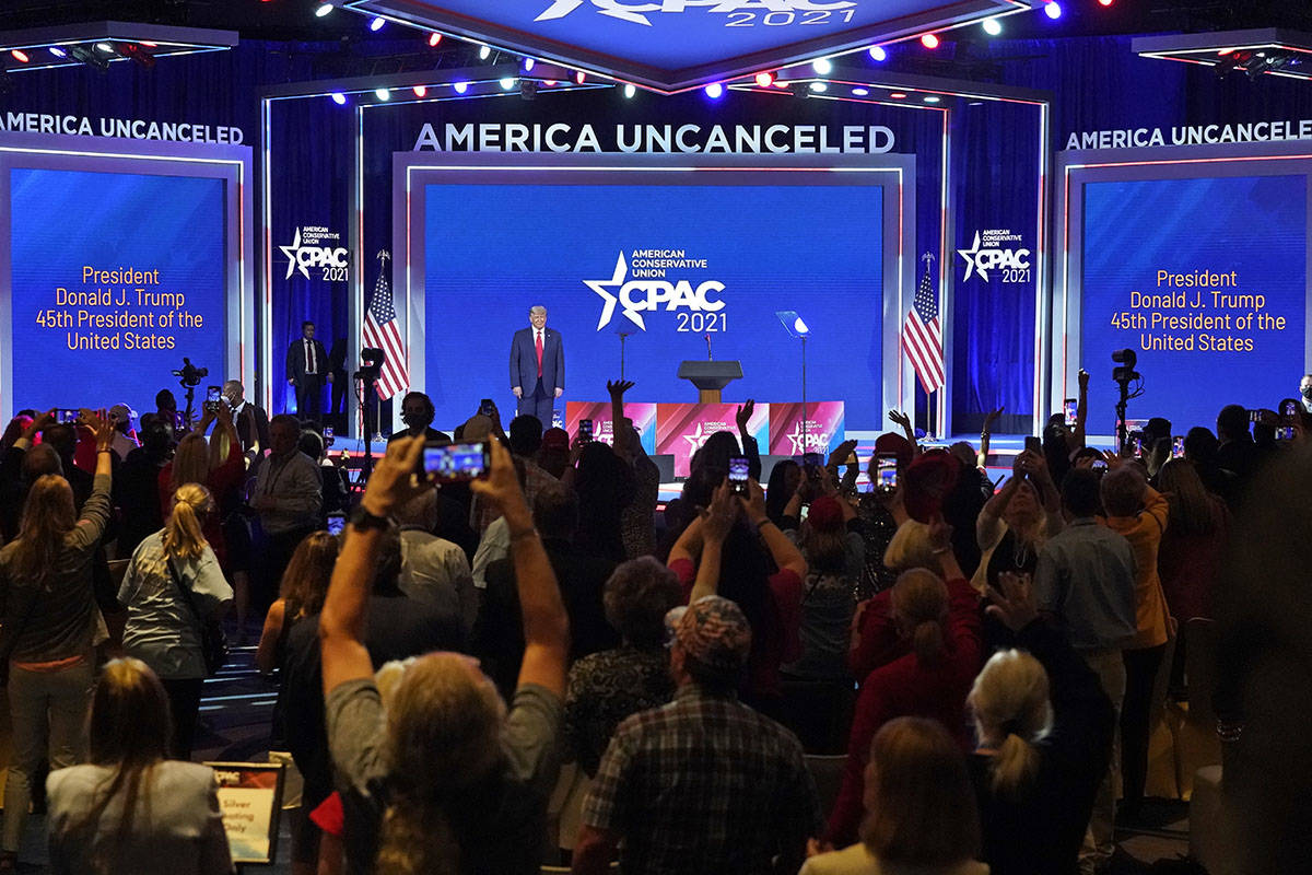 Supporters cheer and wave as former president Donald Trump is introduced at the Conservative Po ...