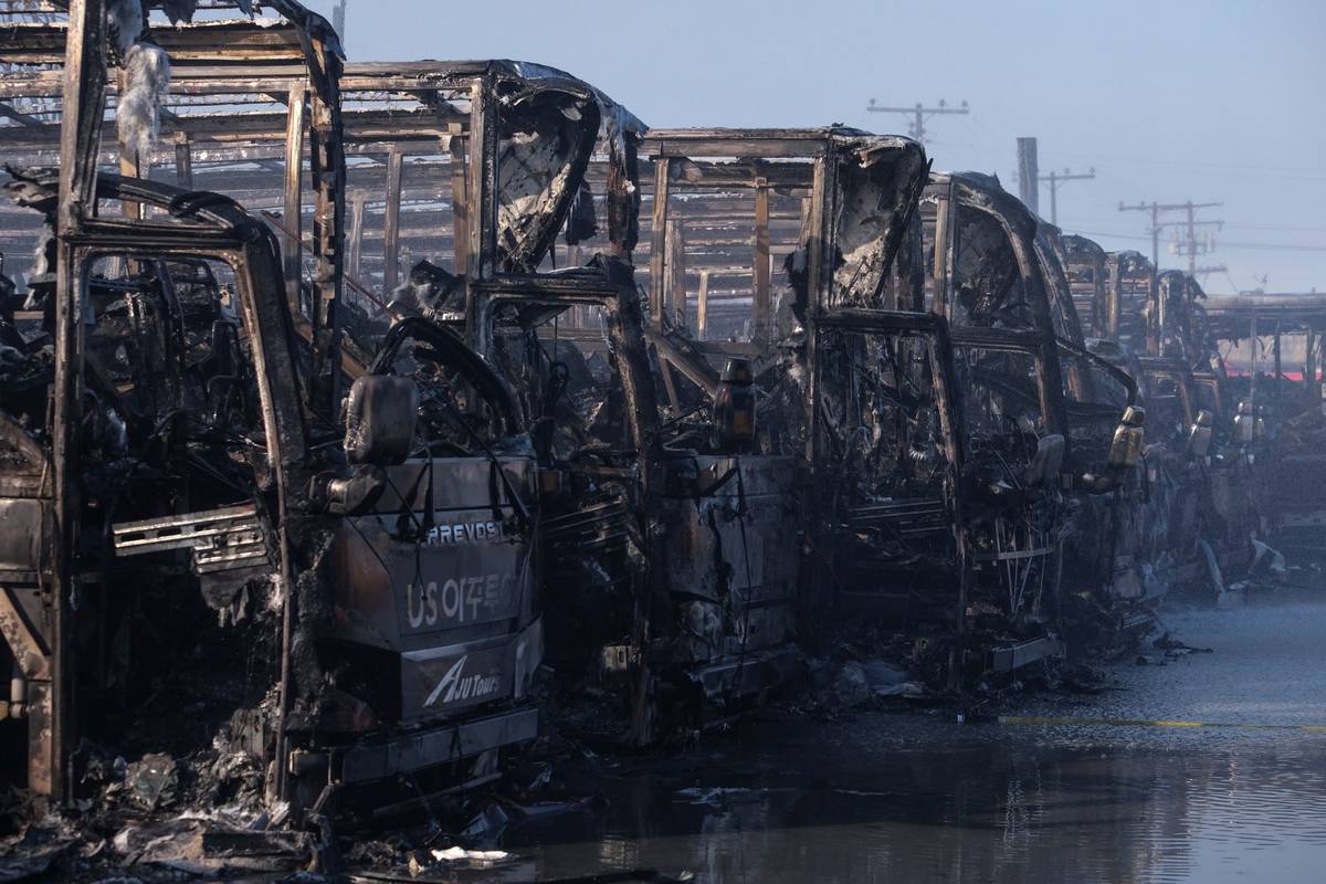 The burned buses are seen at a commercial yard in Compton, Calif., on Friday, Feb. 26, 2021. (A ...