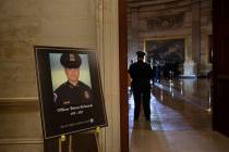 FILE - In this Feb. 2, 2021, file photo a placard is displayed with an image of the late U.S. C ...