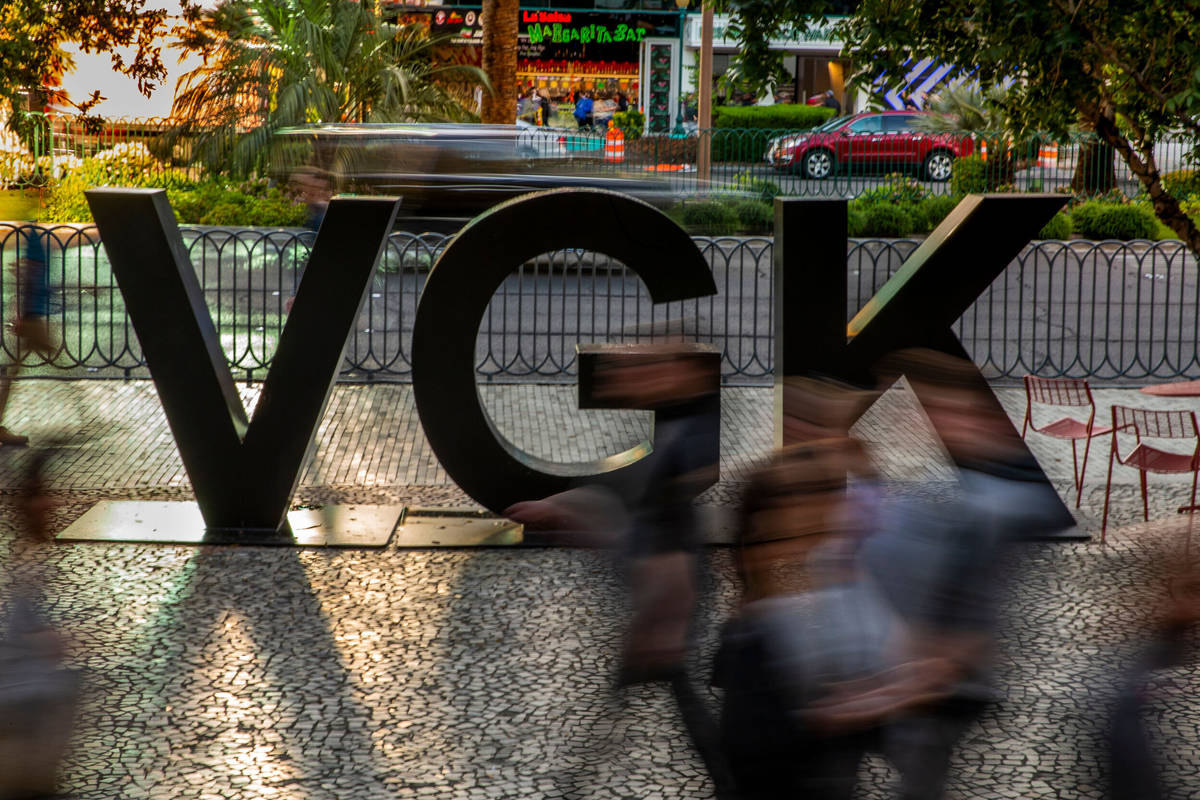 Fans stream by a VGK logo on Las Vegas Blvd. before the start of Game 4 of an NHL Western Confe ...