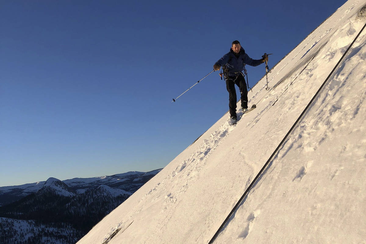 In this photo provided by Jason Torlano, Zach Milligan is shown on his descent down Half Dome i ...