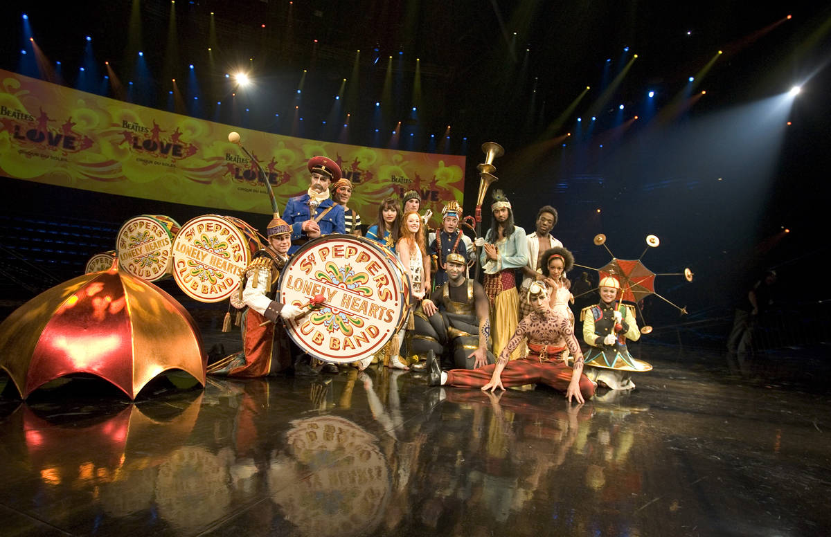 Cast members of Cirque du Soleil's LOVE poise for photographs during a media preview of the sho ...
