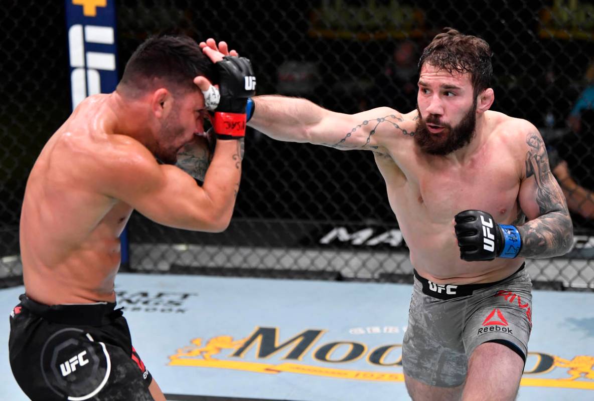 LAS VEGAS, NEVADA - FEBRUARY 27: (R-L) Jimmie Rivera punches Pedro Munhoz of Brazil in a bantam ...