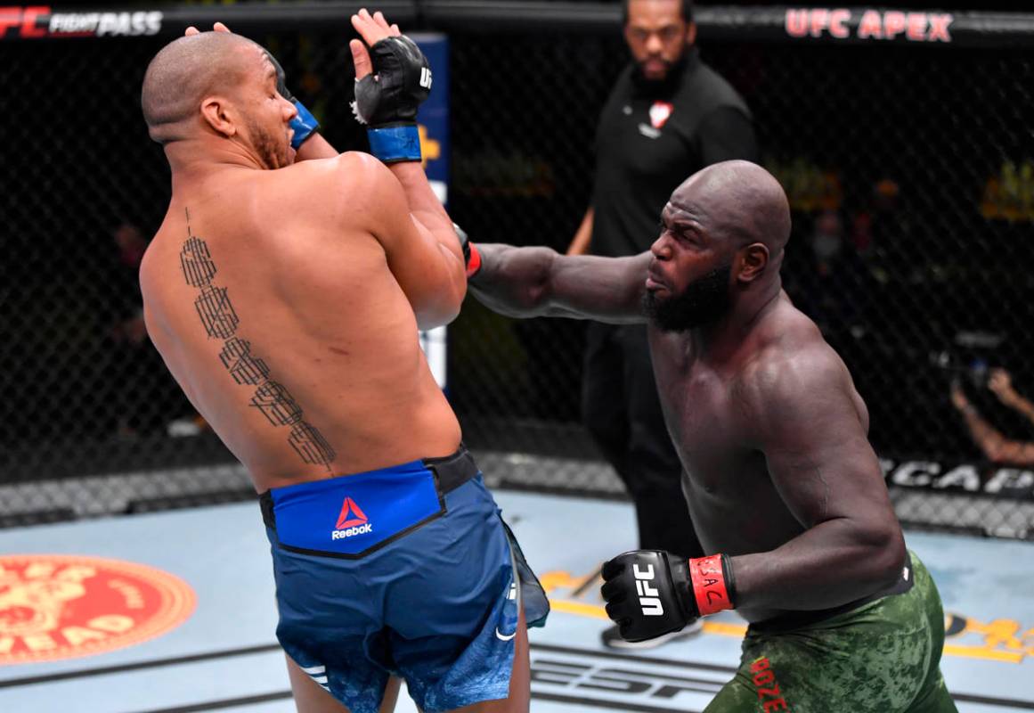 LAS VEGAS, NEVADA - FEBRUARY 27: (R-L) Jairzinho Rozenstruik of Suriname punches Ciryl Gane of ...