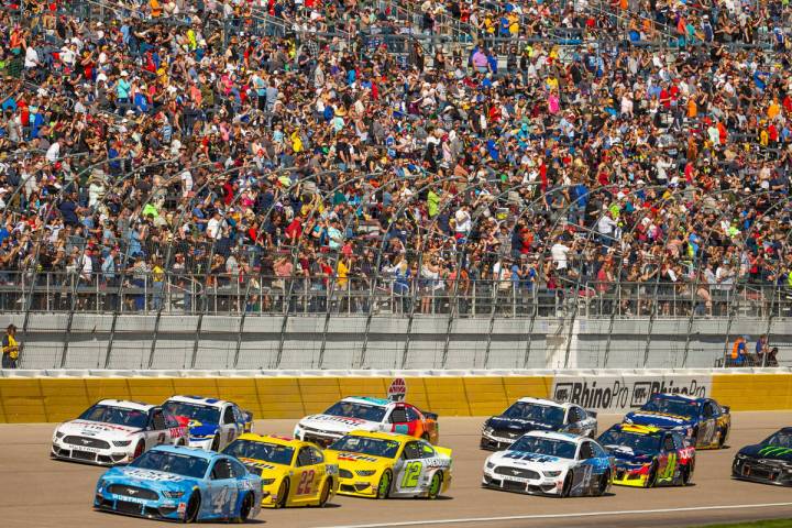Kevin Harvick (4, bottom left) leads the race heading into turn one during the Pennzoil 400 pre ...