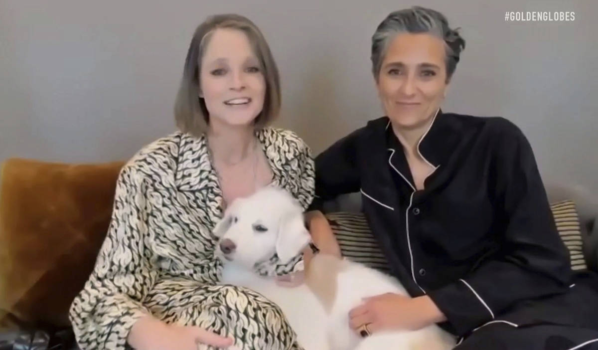 In this video grab issued Sunday, Feb. 28, 2021, by NBC, Jodie Foster, left, holding her dog Zi ...