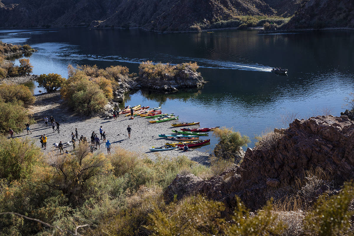 Kayakers rest on a beach along the Colorado River near Willow Beach in Ariz., Saturday, Dec. 5, ...