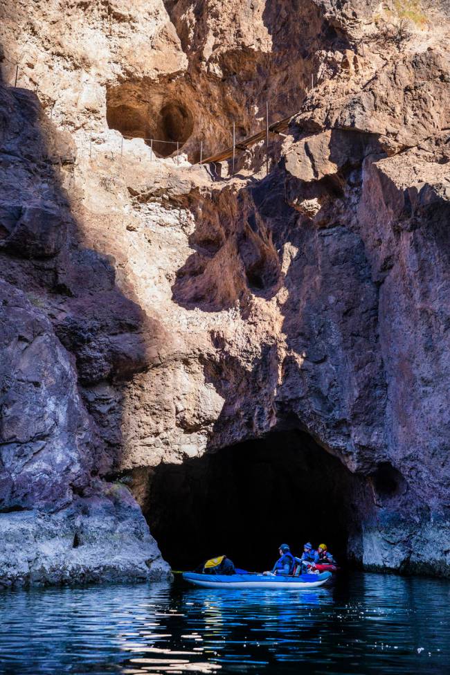 Kayakers emerge from Emerald Cave, which in spring and summer sparkles kaleidoscopically throug ...