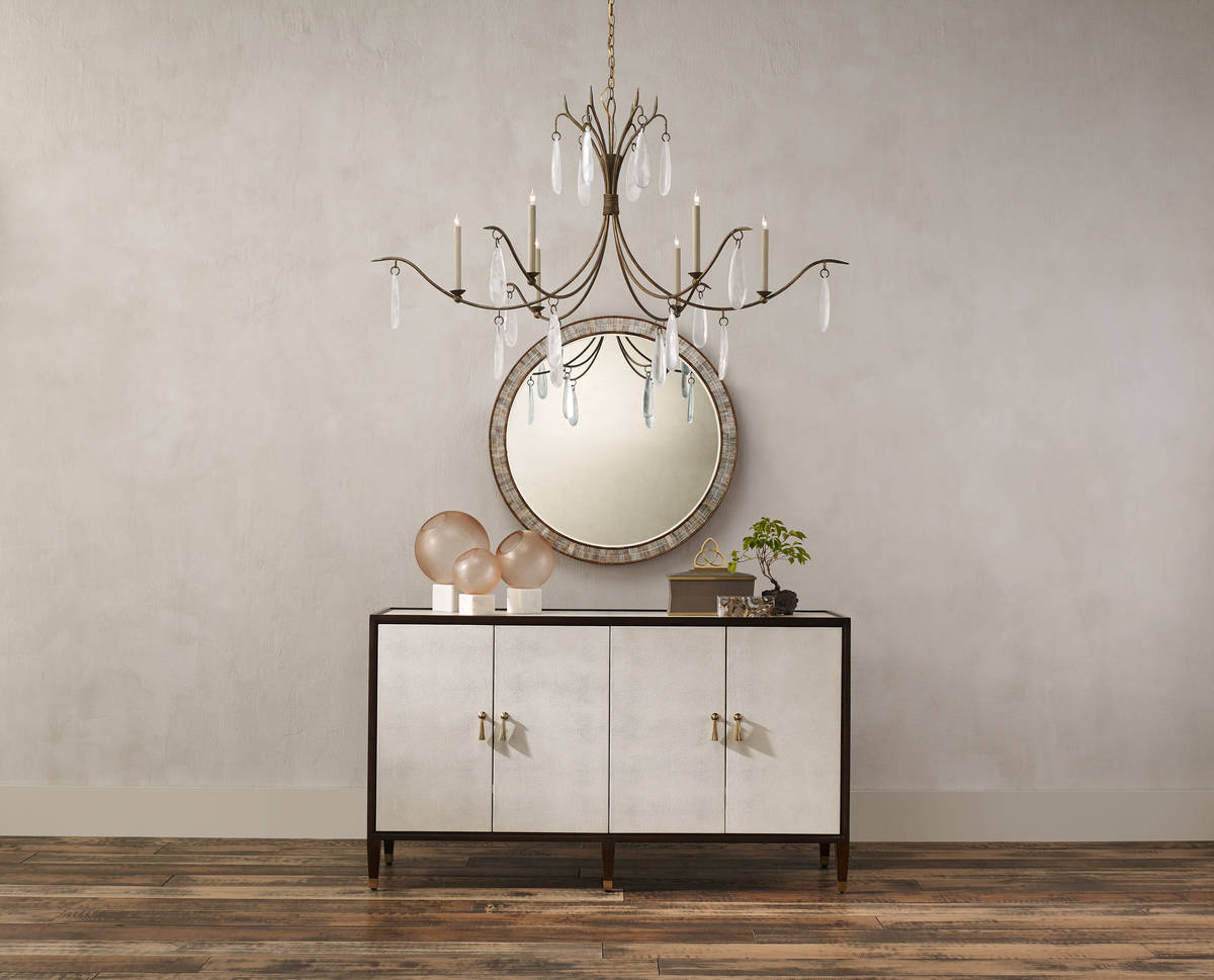 The Marshallia Chandelier, made of wrought iron in a rustic gold finish, has slender arms dripp ...