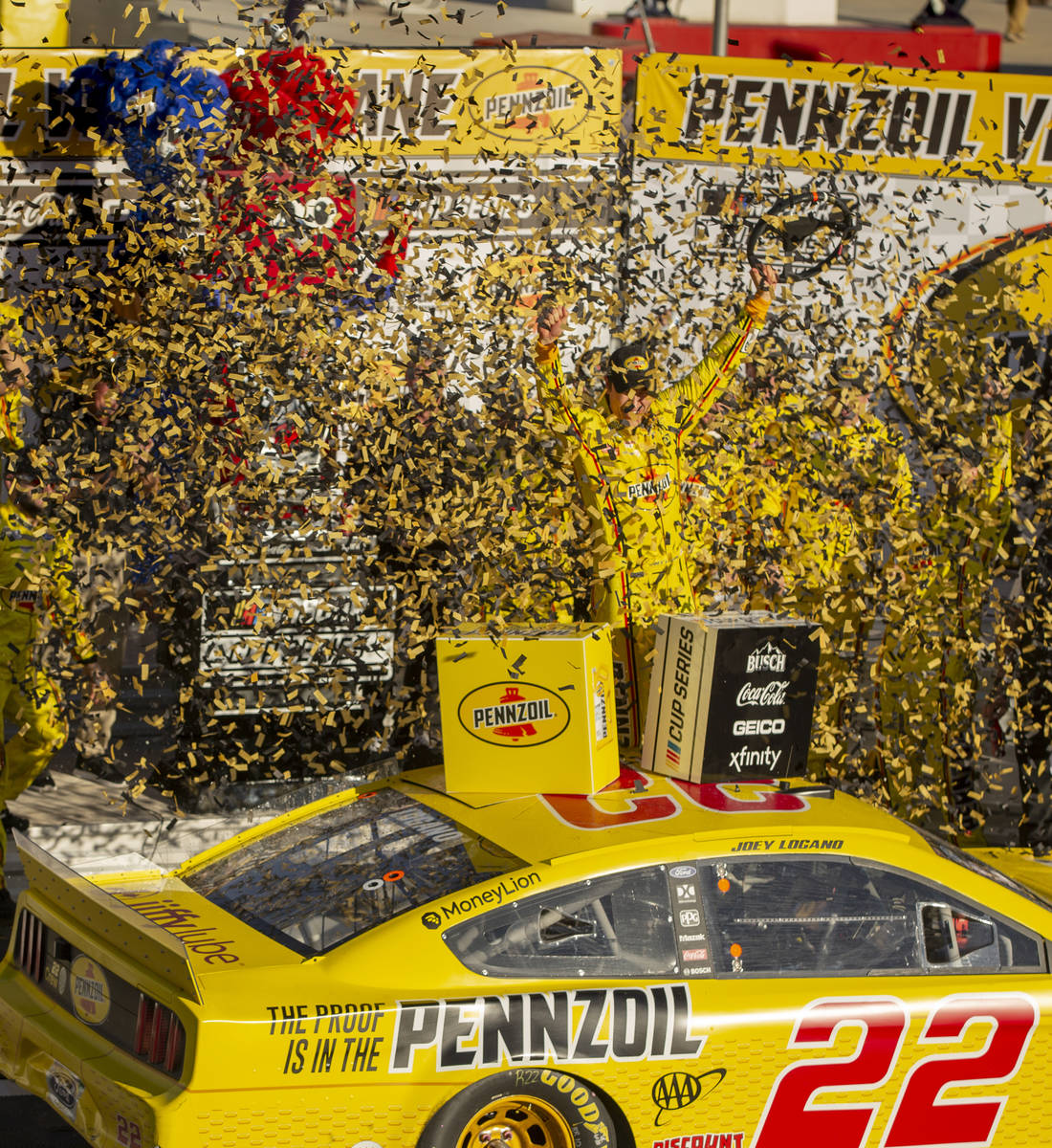 Joey Logano (22) is blasted with confetti as he celebrates in the winner's circle following the ...