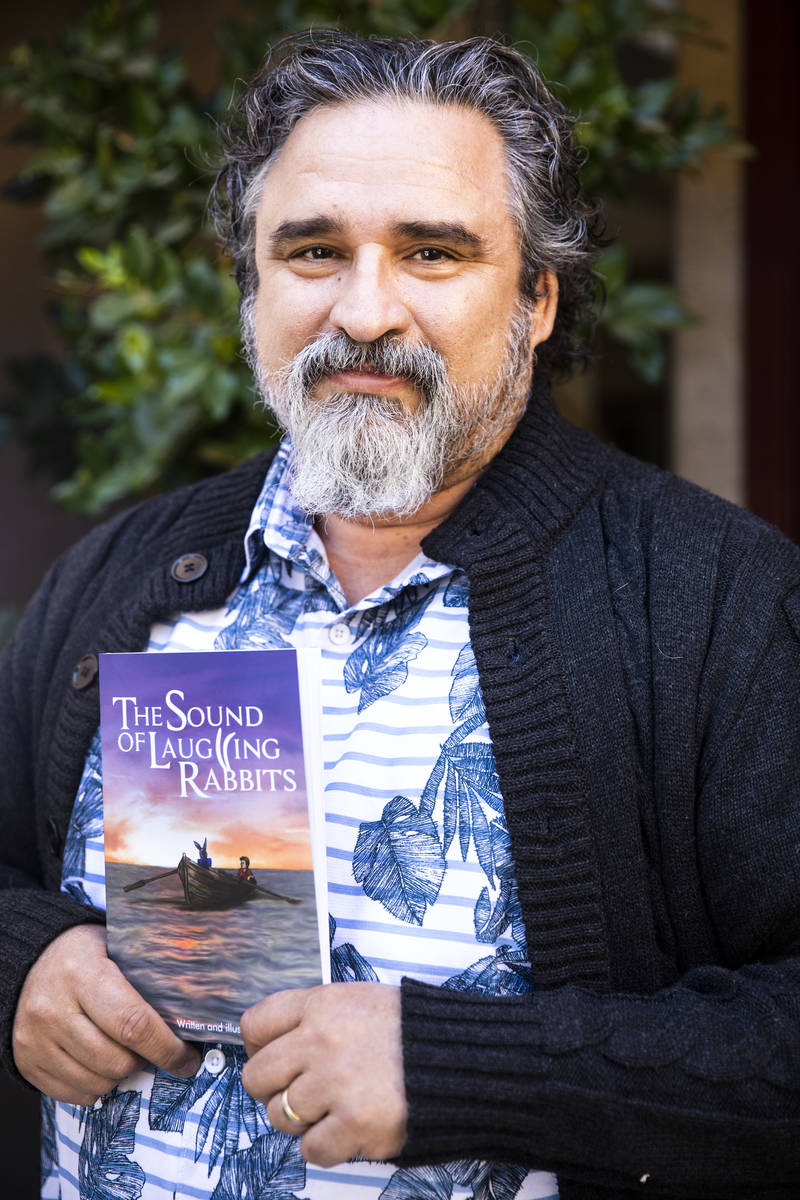 Henderson resident Alex Raffi holds "The Sound of Laughing Rabbits," which he wrote and illustr ...