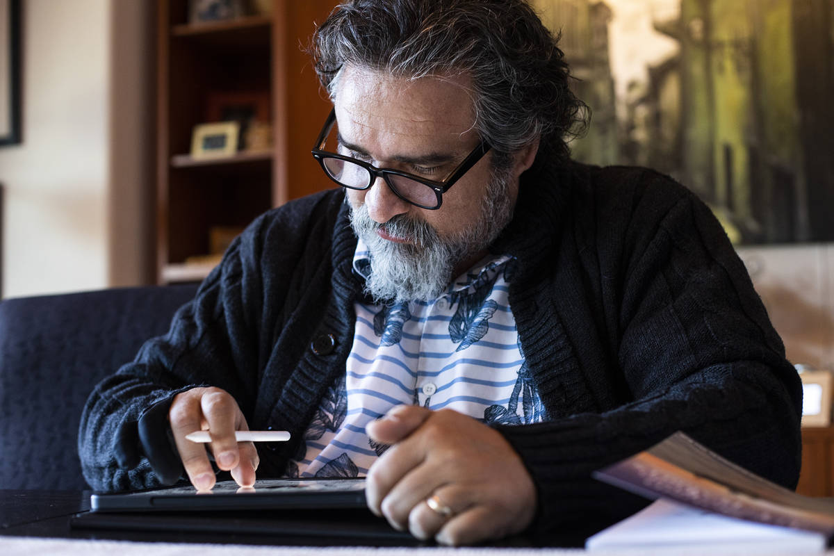 Alex Raffi draws on his iPad at his home in Henderson. He wrote and illustrated "The Sound of L ...