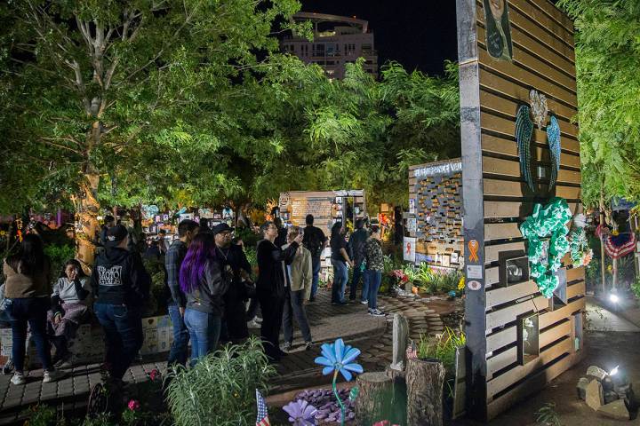 Visitors walk through the Las Vegas Community Healing Garden before the start of a ceremony hon ...