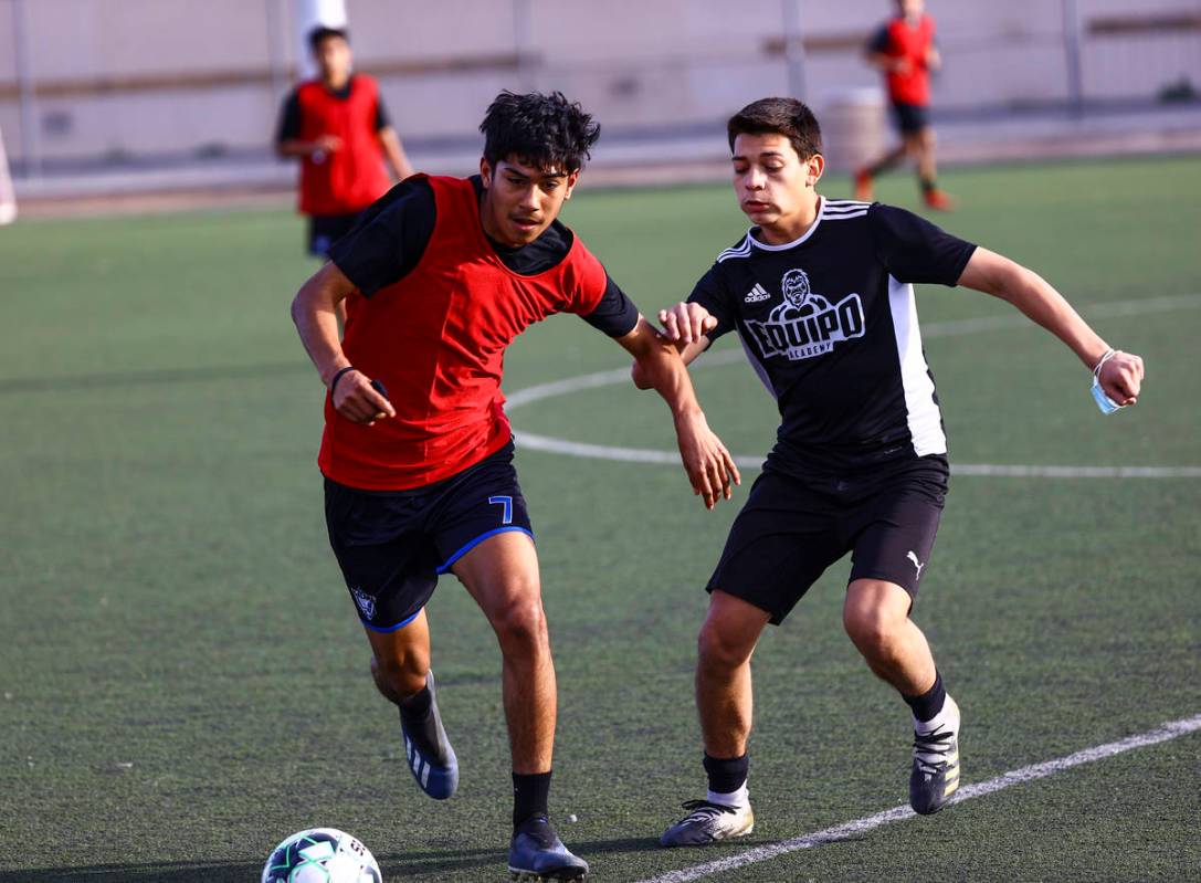 Equipo Academy's Valentin Ruiz, left, and Hanzel Padilla battle for the ball during soccer prac ...