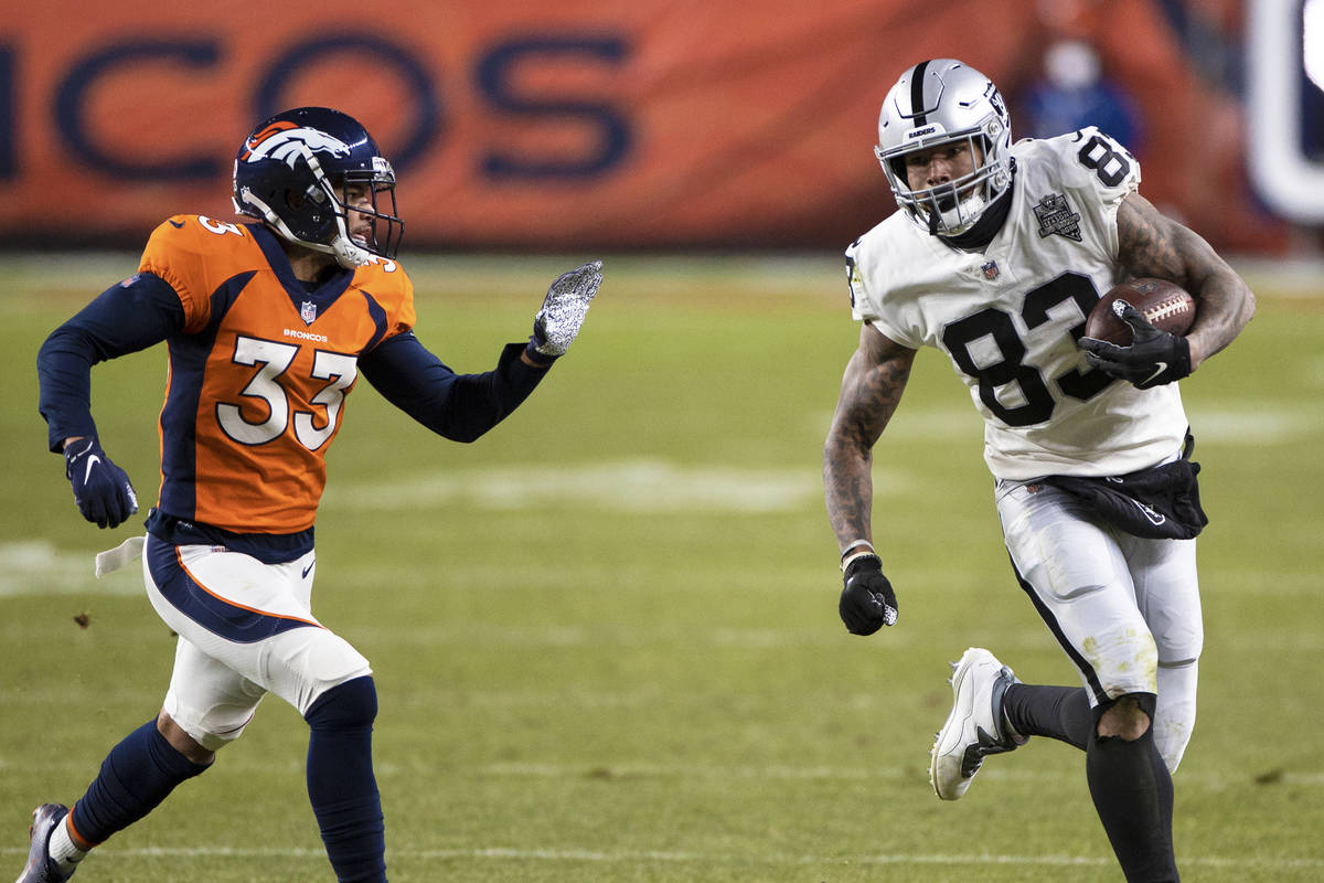 Raiders tight end Darren Waller (83) breaks into the open field past Denver Broncos safety Alij ...