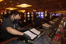 In this July 7, 2020, file photo, International Game Technology, IGT, technician Saul Rivera in ...