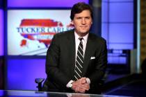 Tucker Carlson, host of "Tucker Carlson Tonight," poses for photos in a Fox News Channel studio ...