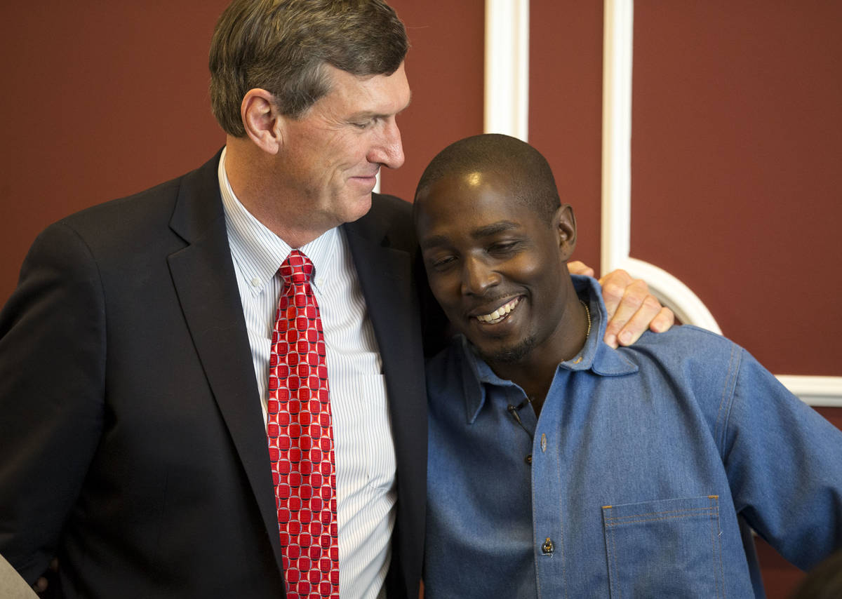 In this June 30, 2017, file photo, DeMarlo Berry hugs his attorney Lynn Davies following a news ...