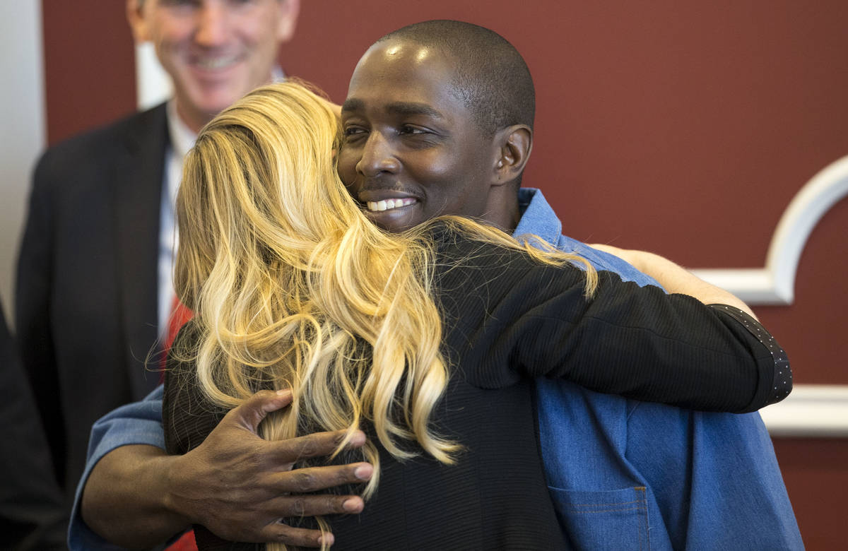 In this June 30, 2017, file photo, DeMarlo Berry hugs his attorney Samantha Wilcox following a ...