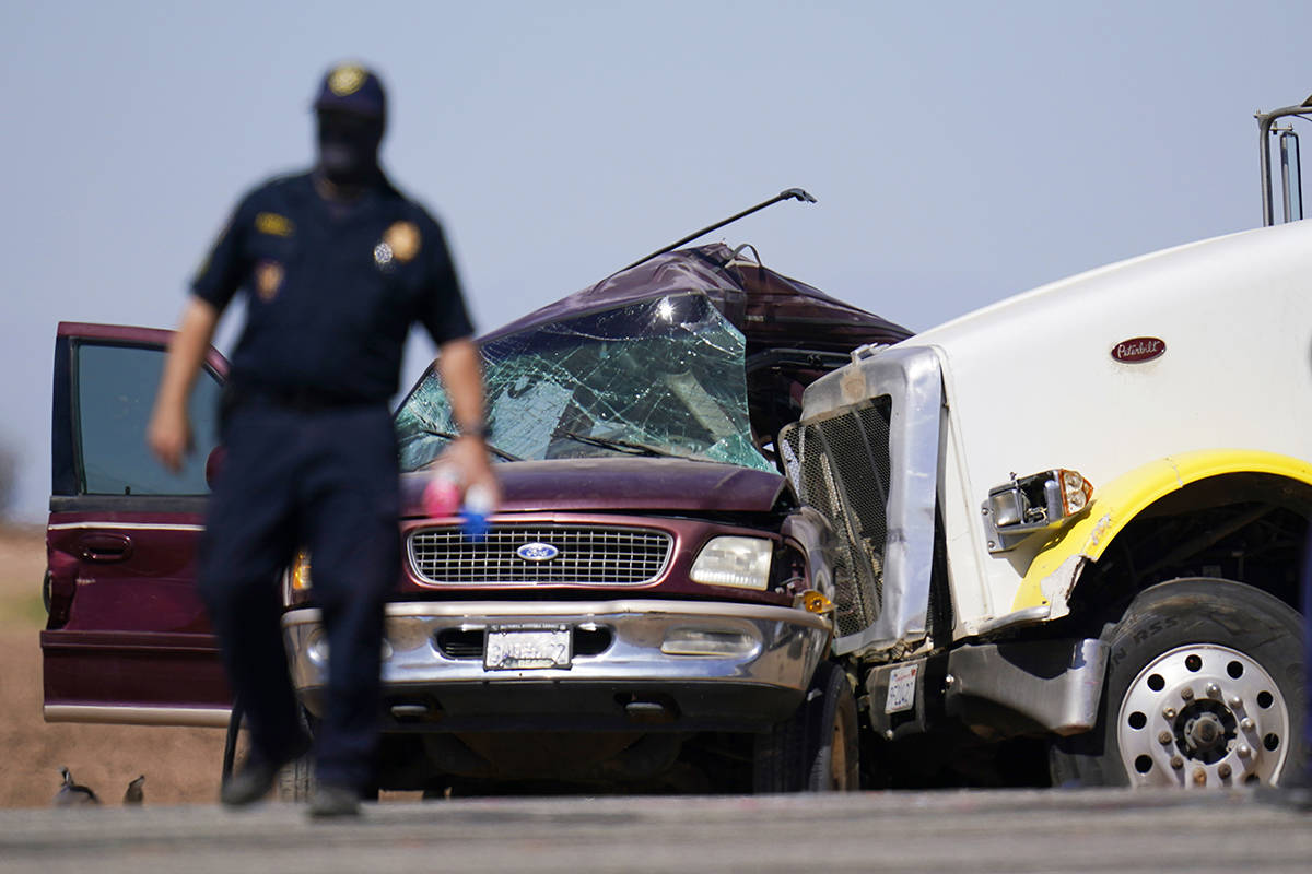 Law enforcement officers work at the scene of a deadly crash in Holtville, Calif., on Tuesday, ...