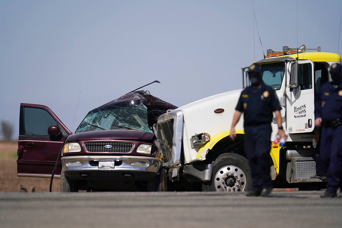Law enforcement officers work at the scene of a deadly crash in Holtville, Calif., on Tuesday, ...