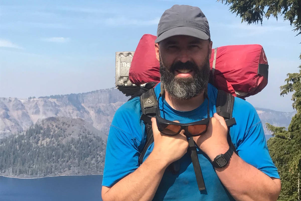 Premium AI Image | Hiker poses in front of a mountain range while on an  adventure and retirement hike GENERATE AI