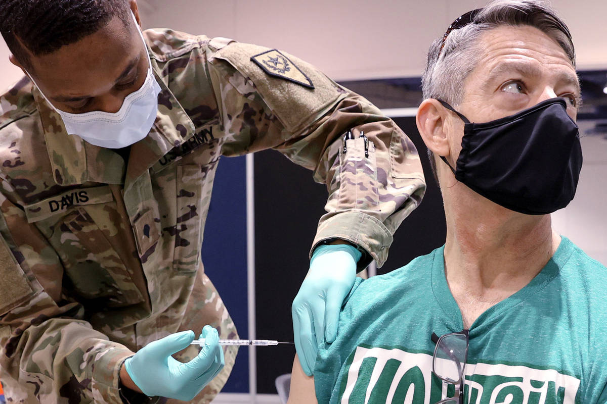 Pat McKeever, 53, who is a pilot with Southwest Airlines, receives the COVID-19 vaccine from Ne ...