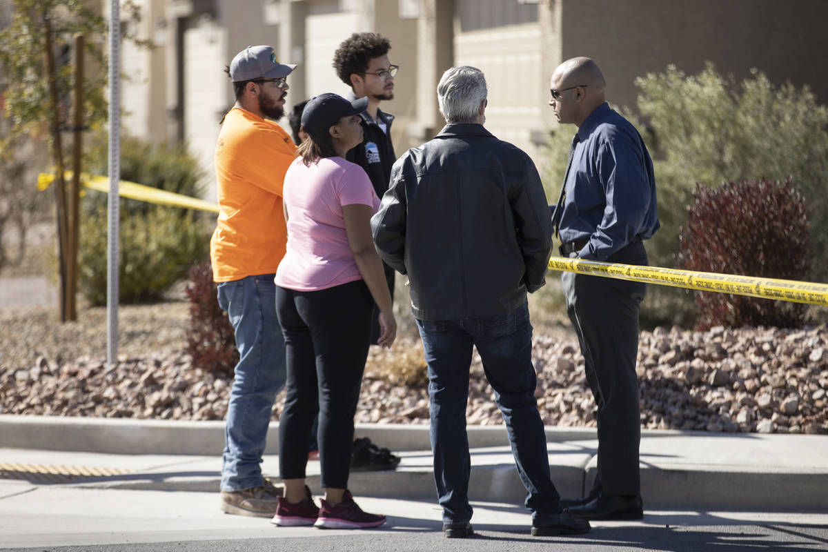 Metropolitan Police Department homicide Lt. Ray Spencer talks with people while investigating a ...