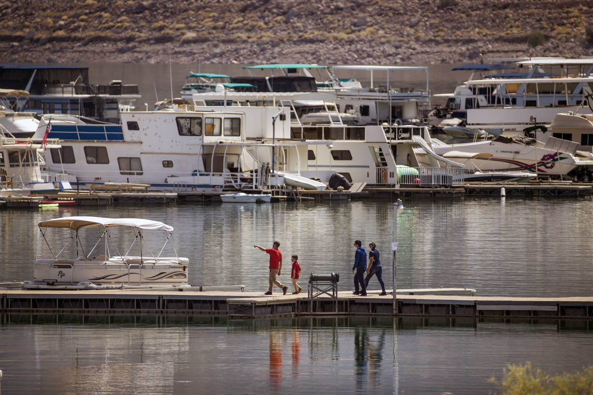 People walk along a dock at the Lake Mead Marina about the Lake Mead National Recreation Area T ...