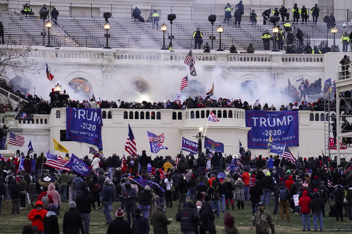 In a Wednesday, Jan. 6, 2021, file photo, rioters storm the Capitol, in Washington. At least 10 ...