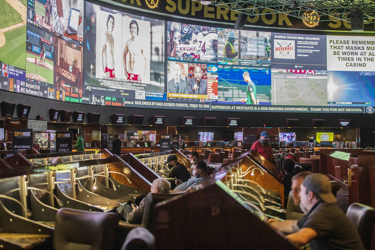 Guests watch the screens at the Westgate sportsbook in Las Vegas, Wednesday, March 3, 2021. (Ra ...