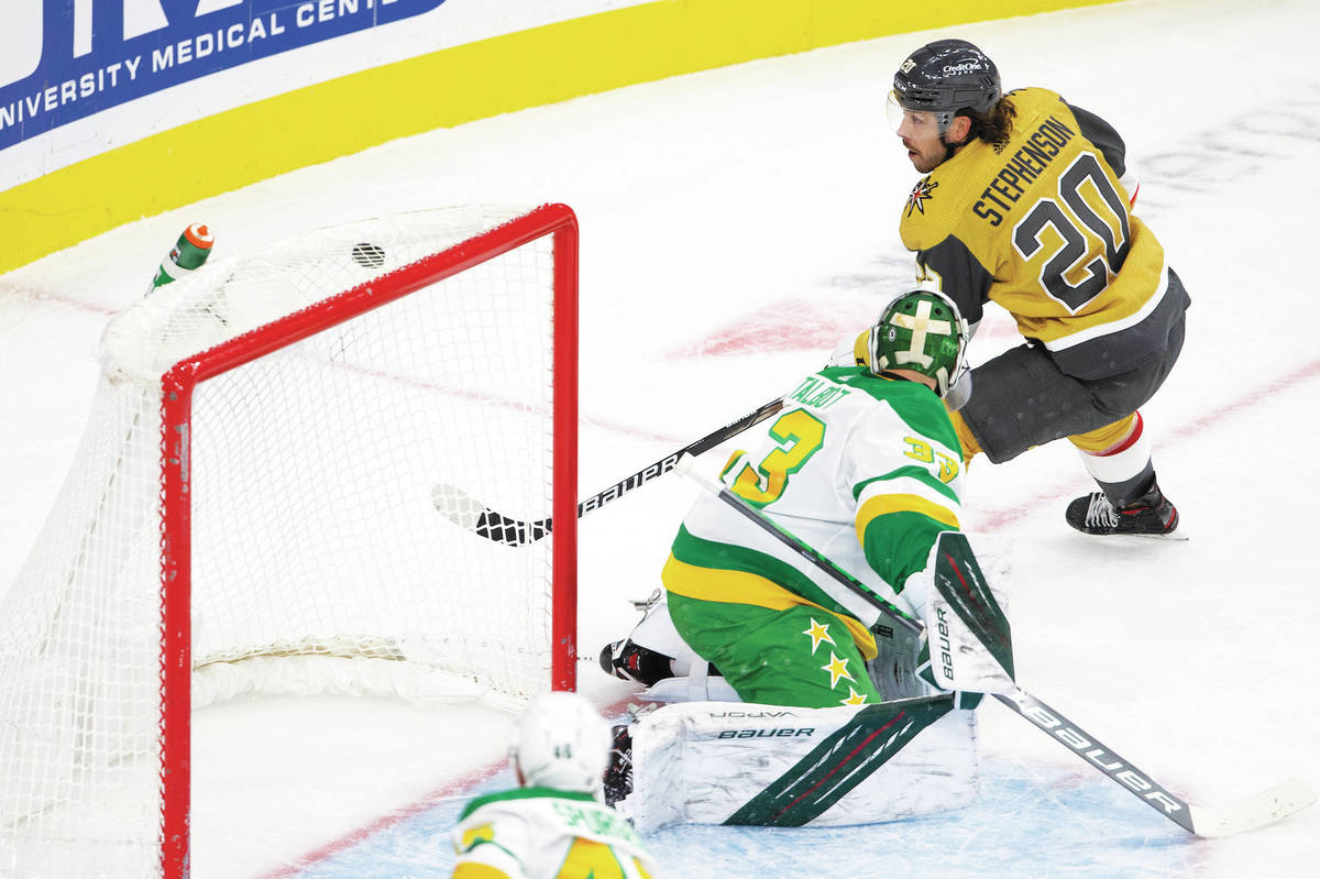 Golden Knights center Chandler Stephenson (20) scores a goal on Wild goaltender Cam Talbot (33) ...