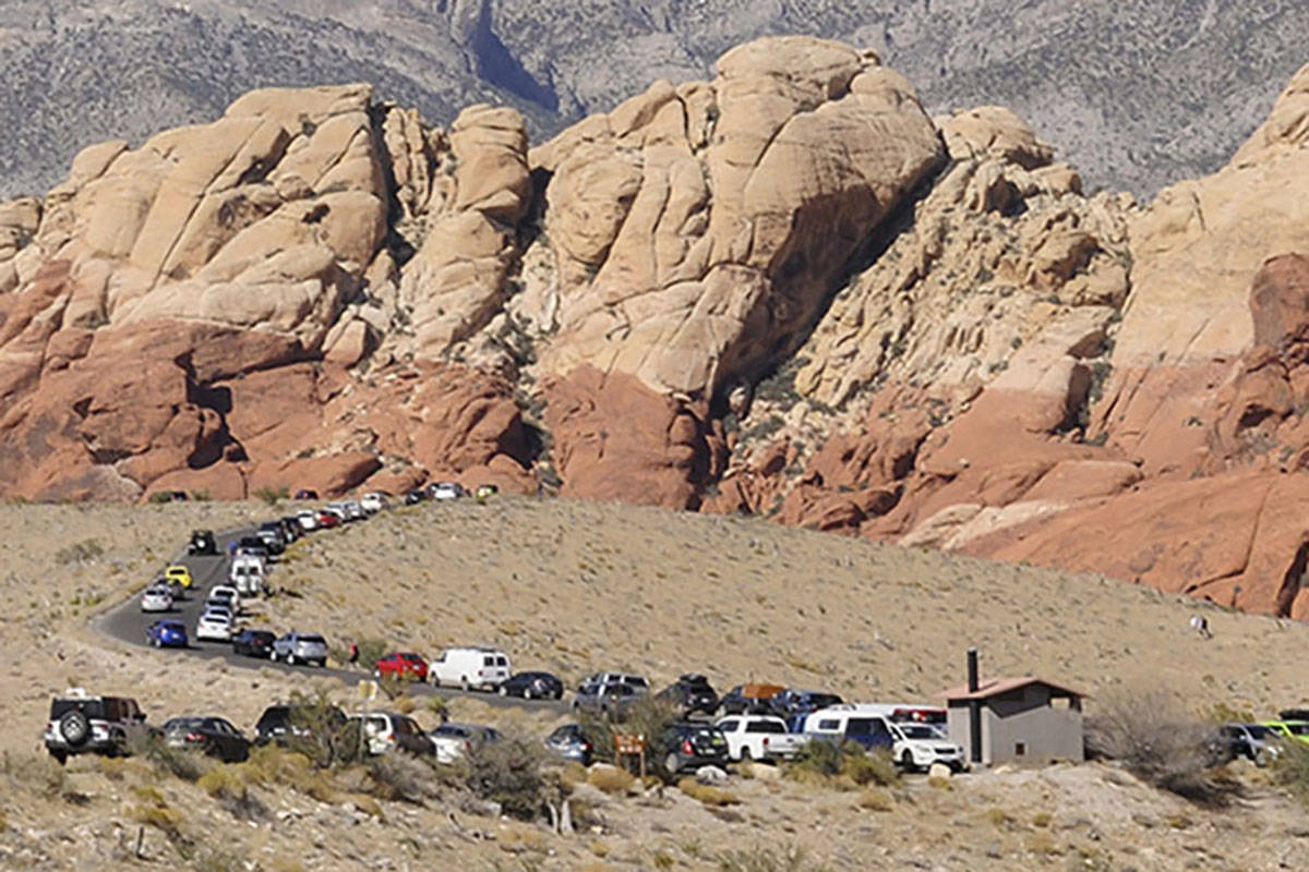 Parked vehicles stretch along the Red Rock Loop Road on a busy day at the Red Rock National Con ...