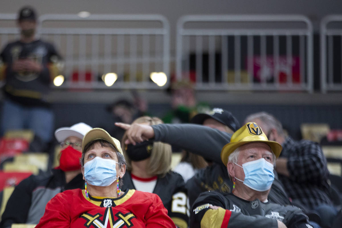 Golden Knights fans wear personal protective equipment to prevent the spread of COVID-19 before ...