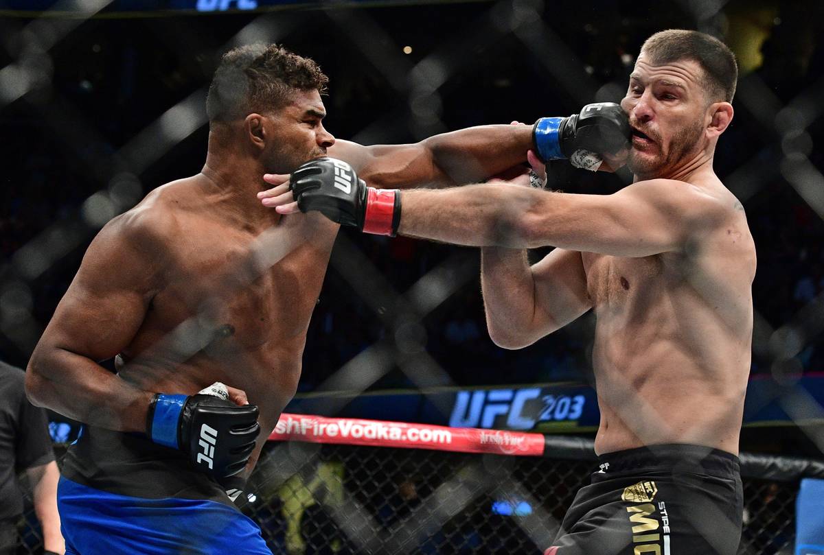 Alistair Overeem, left, from the Netherlands, punches Stipe Miocic during a heavyweight title b ...