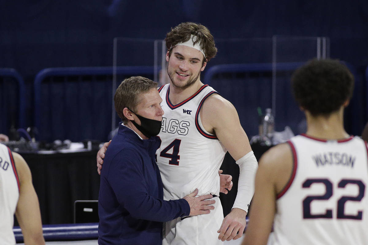 Gonzaga coach Mark Few, left, hugs forward Corey Kispert after Kispert, a senior playing his la ...