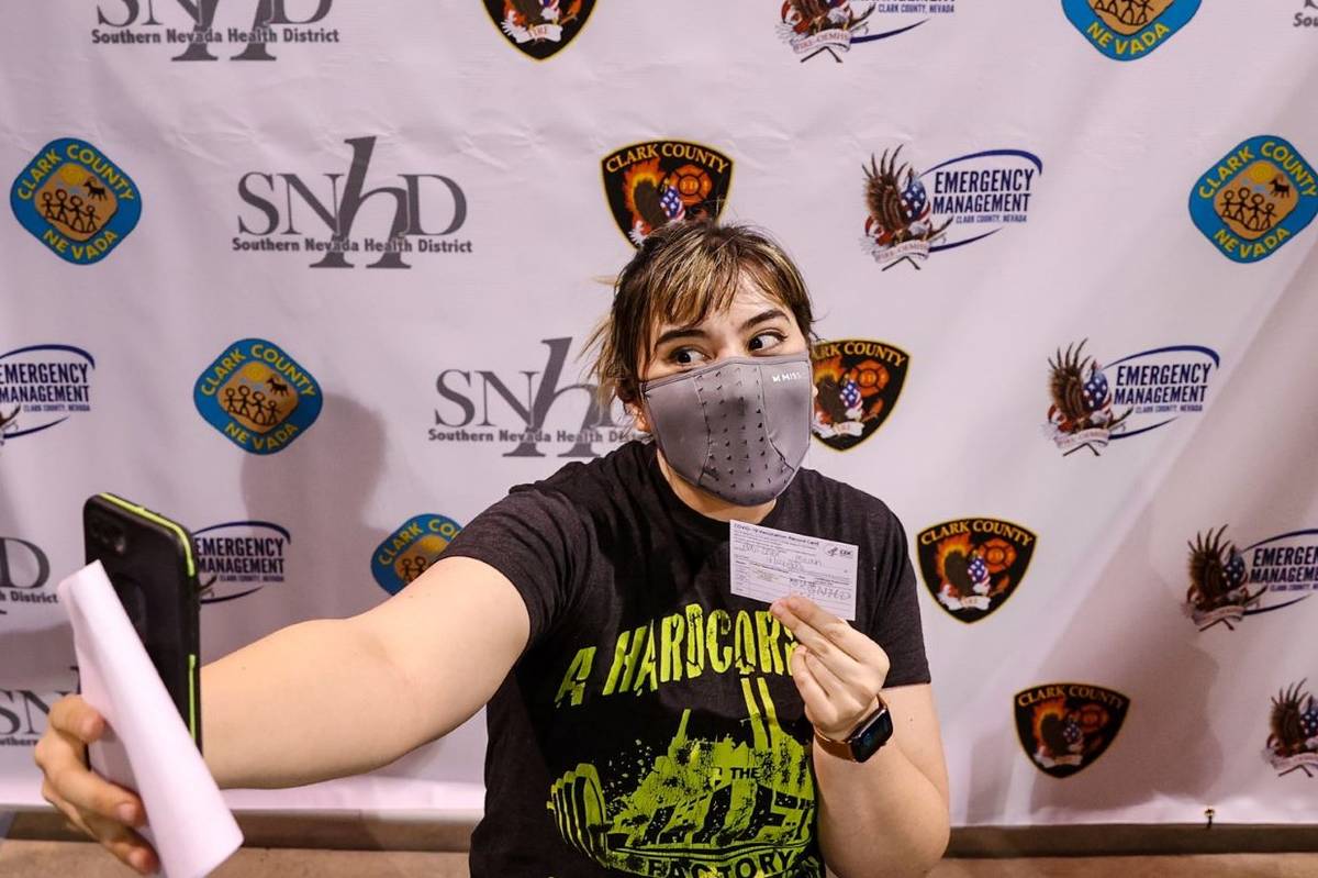 Micah Haji-Sheikh, 27, of North Las Vegas takes a photo in the "Selfie Station" after receiving ...